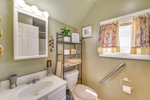 a bathroom with a sink and a toilet and a window at Pet-Friendly Gloversville Cottage Near Golf Course in Gloversville