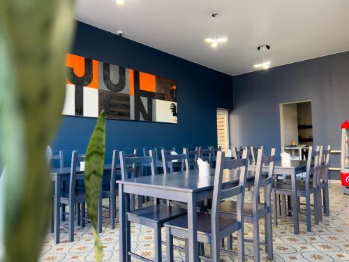 a dining room with blue walls and blue tables and chairs at Hotel Rita House in Pizunda