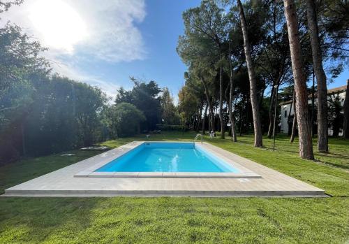 a swimming pool in the middle of a yard with trees at Aurora Holiday House in Vasto