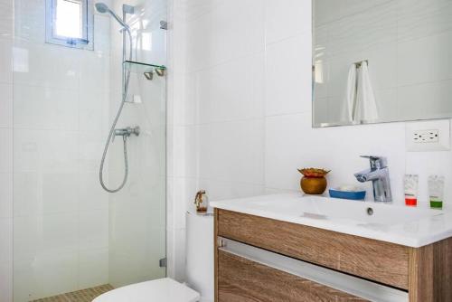 a bathroom with a sink and a shower and a toilet at Comfy Apartment City Center - PH Quartier Atlapa in Panama City