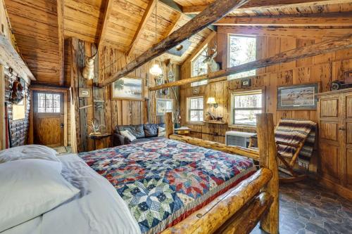 een slaapkamer met een bed in een kamer met houten wanden bij Remote Escape Klamath Falls Cabin By Lake and Hikes in Klamath Falls