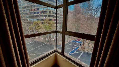 a view from a window of a city at Apartamentos City Centro Los Leones in Santiago