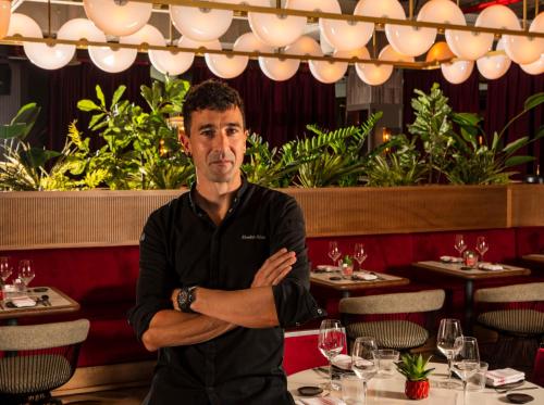 a man sitting at a table in a restaurant at Radisson RED Madrid in Madrid