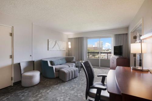 a hotel room with a desk and a living room at Sonesta Select Atlanta Midtown Georgia Tech in Atlanta