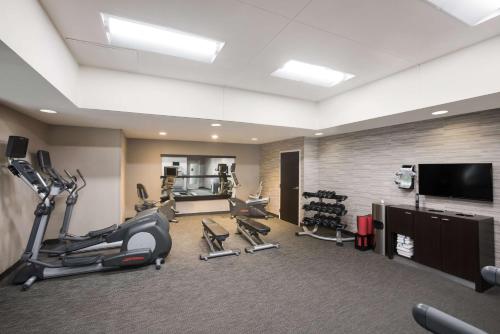 a gym with tread machines and a flat screen tv at Sonesta Select Atlanta Midtown Georgia Tech in Atlanta