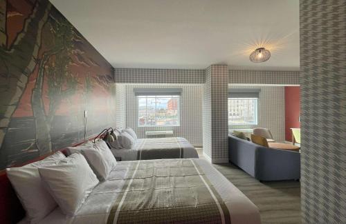 um quarto de hotel com duas camas e um sofá em Superior Shores Hotel, BW Signature Collection by Best Western em Thunder Bay