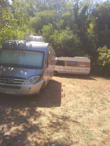 a rv and a bus parked in a field at Auto camp Radoman in Virpazar