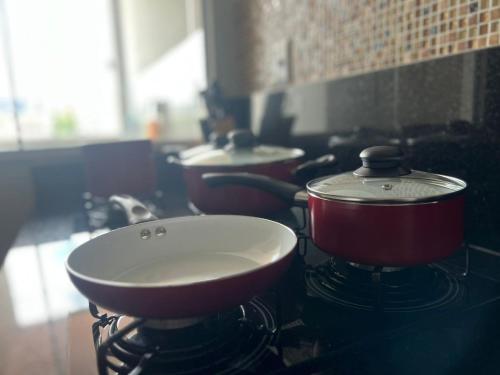 a pot on top of a stove in a kitchen at Hotel APART Zuccolotto 202 in Aracruz