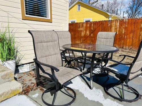 two chairs and a table on a patio at Home Sweet Idahome, feels like home with all the decor you wish you could afford King bed in master, fully fenced dog friendly yard, a few blocks from BSU and downtown Boise, Your perfect stay! in Boise