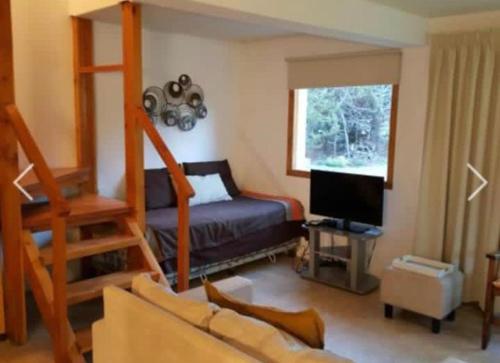 a living room with a bunk bed and a television at Casa Catedral Bariloche in San Carlos de Bariloche