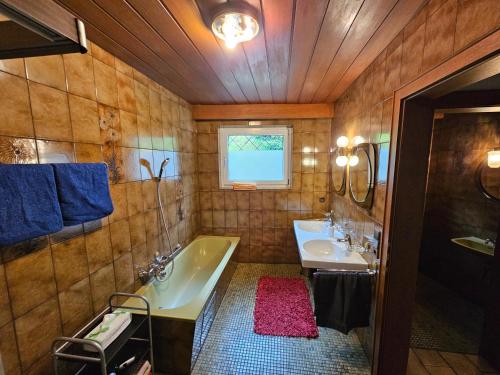 a bathroom with two sinks and a tub at Ferienwohnung Singer in Völs