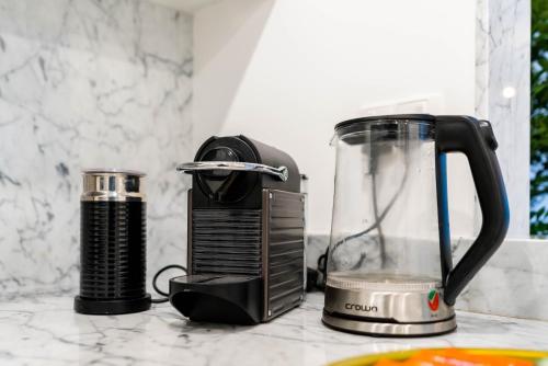 a blender sitting on a kitchen counter next to a blender at Ultimate Stay / Burj Al Arab View / Brand New / Amazing Pool with a View / Perfect Holiday / Madinat Jumeirah / 2 BDR in Dubai