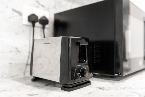 a toaster oven sitting on top of a counter at Ultimate Stay / Burj Al Arab View / Brand New / Amazing Pool with a View / Perfect Holiday / Madinat Jumeirah / 2 BDR in Dubai