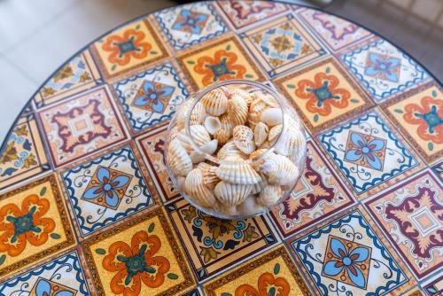a bowl of shells sitting on top of a table at Ultimate Stay / Burj Al Arab View / Brand New / Amazing Pool with a View / Perfect Holiday / Madinat Jumeirah / 2 BDR in Dubai