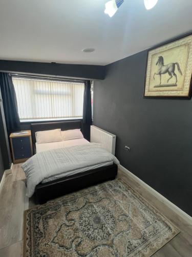 a bedroom with a bed and a rug on the floor at Rooms in Surrey in Laleham