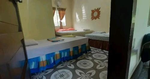 a room with two beds and a mirror at Cocos Hostel in Moyogalpa