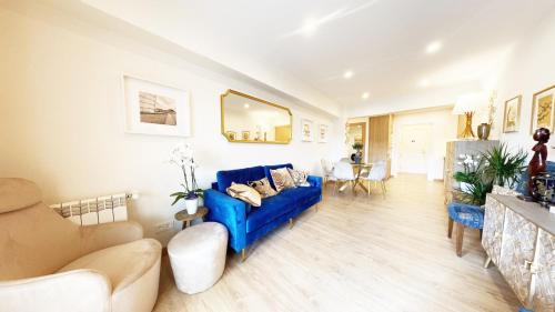 a living room with a blue couch and a table at Paradise Luxurious apartment, 3 double rooms for 6 guests, 4 beds, terrace, jacuzzi, free parking, new in Donostia-San Sebastián