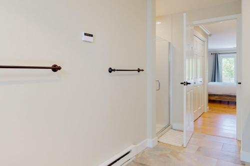 a white hallway with a door and a bedroom at Chipper View in Jackson