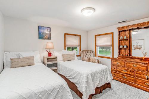 a bedroom with two beds and a dresser at Lakeside Living in Lakeside