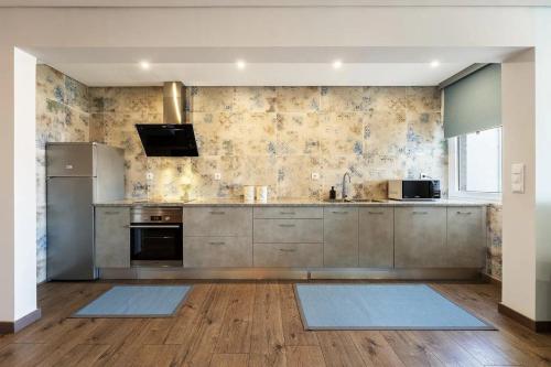 a kitchen with wooden floors and stainless steel appliances at Beach Retreat in Torres Vedras