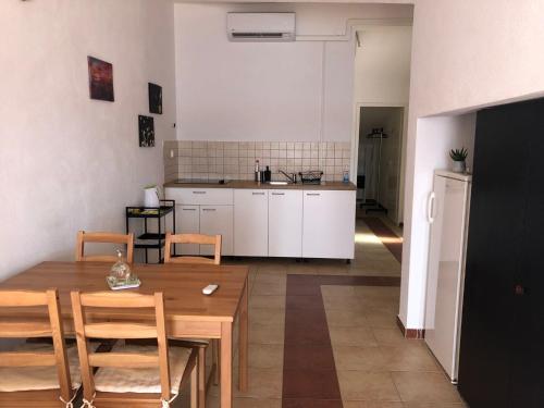 a kitchen and dining room with a table and chairs at Apartments by the sea Zivogosce - Porat, Makarska - 21141 in Živogošće