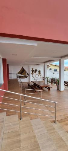 a room with a red ceiling and a wooden floor at Pousada Litorânea in São Luís