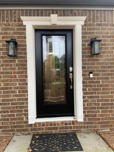 a black door on the side of a brick building at Renovated 3bedroom 2.5bath 2 story house w/ garage in Lawrenceville