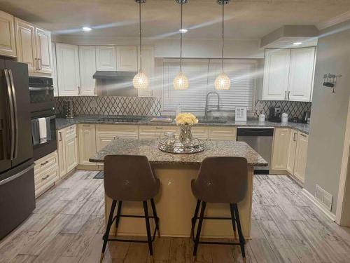 a kitchen with a center island with two bar stools at Renovated 3bedroom 2.5bath 2 story house w/ garage in Lawrenceville
