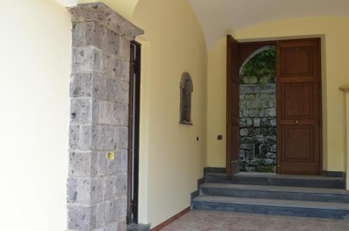 an entrance to a house with a wooden door at Il Rivolo in Sorrento