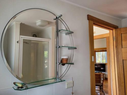 a mirror on a wall in a room at The Dunes - King Studio - 50m from Scamander Beach in Scamander