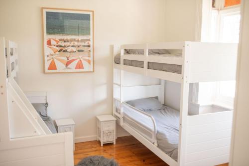 a room with two bunk beds and a staircase at Victorian Coastal in Portarlington