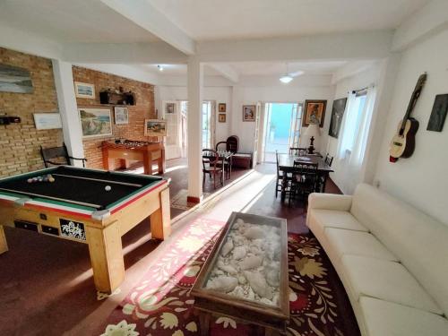 a living room with a pool table in it at Renoah Pousada in Ubatuba