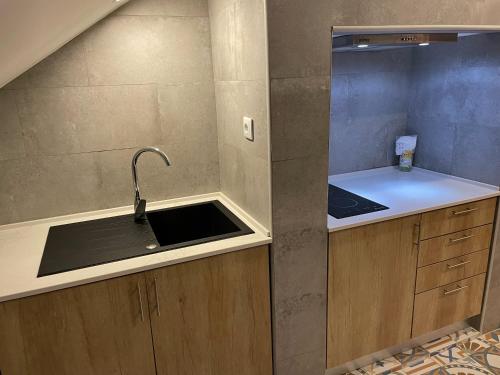 a kitchen with a sink and a counter top at Salero Guest House in Loures