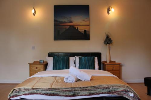 a bedroom with a bed with a stuffed animal on it at Remarc Guest House in Takeley