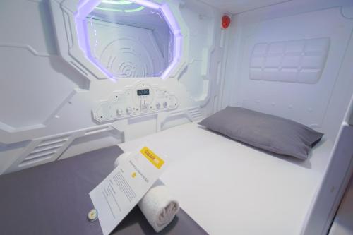 A bed or beds in a room at Capsule Inn Bali