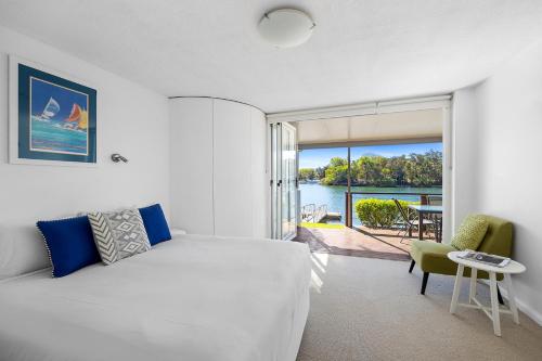 a bedroom with a bed and a view of the water at Noosa Haven Apt 6 Riverside Retreat in Noosaville