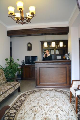 a woman taking a picture in a mirror in a salon at Hotel President in Satu Mare