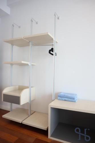 a room with white shelves and a table at Homesuite' Home at The Loft in Kota Kinabalu