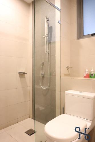 a bathroom with a toilet and a glass shower at Homesuite' Home at The Loft in Kota Kinabalu