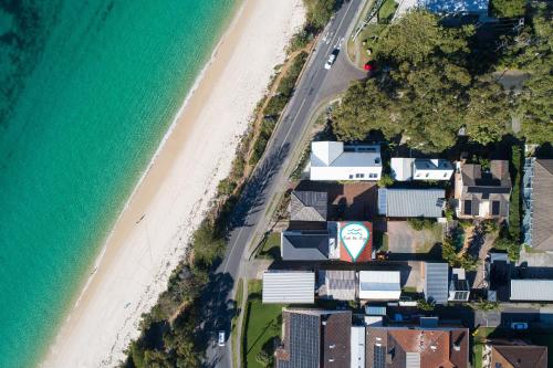 an aerial view of a beach with houses and the ocean at Moana Blue in Shoal Bay