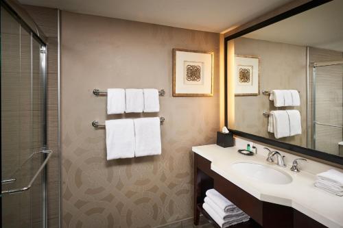 a bathroom with a sink and a shower at Sheraton Hamilton Hotel in Hamilton