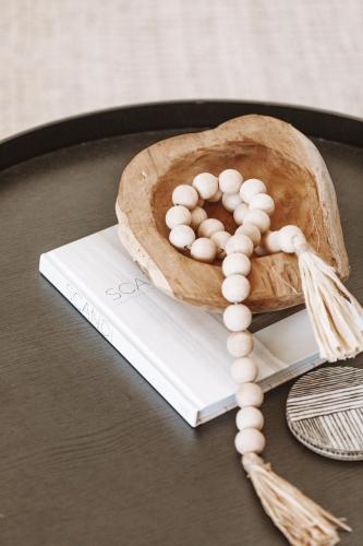 a table topped with a book with a acorn at 1900's cosy cottage - Peaceful couples retreat in the heart of McLaren Vale in McLaren Vale