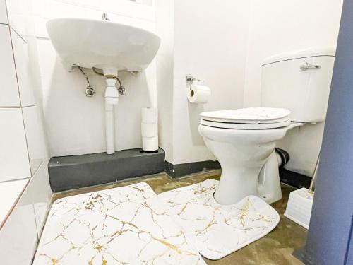 a bathroom with a white toilet and a sink at Cosy Home away from home in Johannesburg