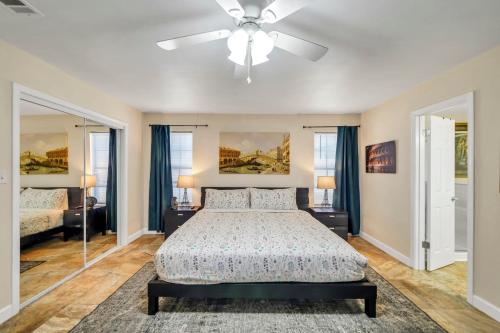 a bedroom with a bed and a ceiling fan at Verb - Arcades, Grill, Gym, Piano, Pong, & Beach! in Fort Walton Beach