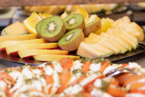 a plate of fruit and vegetables on a table at Parkhotel del Mar in Sassnitz