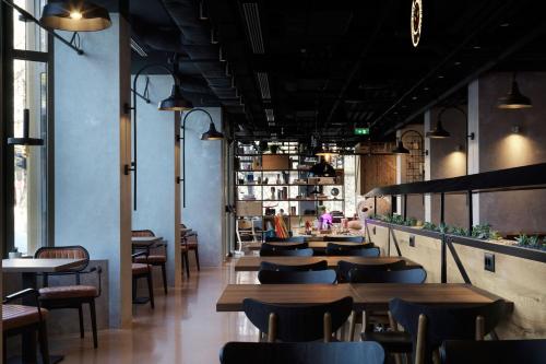 a row of tables and chairs in a restaurant at Moxy Belgrade in Belgrade