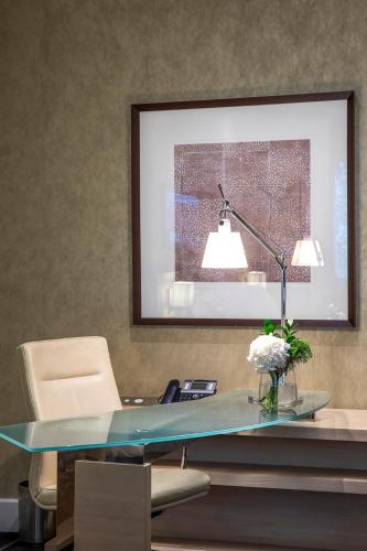 an office with a glass desk with a lamp at InterContinental Melbourne The Rialto by IHG in Melbourne