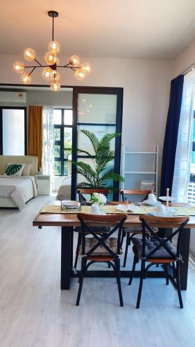 a dining room with a table and two chairs at Mango House3-LuxurySweet I Biggest unit I infinity pool I Wifi-JQ in Kota Kinabalu