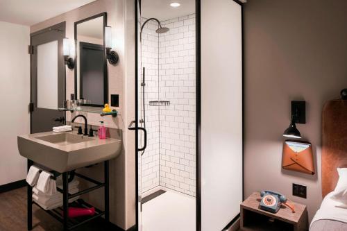 uma casa de banho com um lavatório e um chuveiro em Moxy Chicago Downtown em Chicago