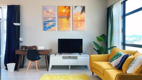 a living room with a yellow couch and a tv at Mango House3-LuxurySweet I Biggest unit I infinity pool I Wifi-JQ in Kota Kinabalu